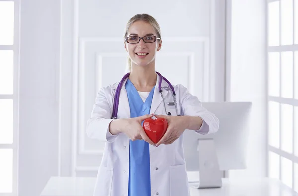 Doctor with stethoscope holding heart, isolated on white background — Stock Photo, Image