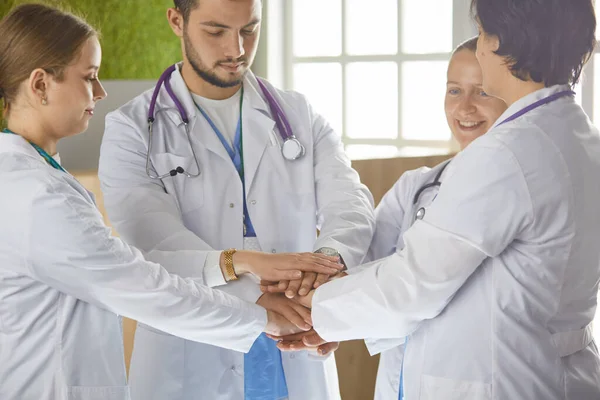 Team of medical workers holding hands together indoors, above view. Unity concept — Stock Photo, Image