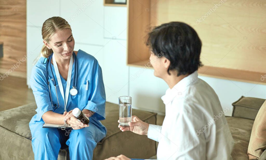 Beautiful smiling woman the doctor in a bottle of pill offers the patient. A panacea or life-saving antidepressant from a legal store prescribes vitamin health care for a healthy lifestyle