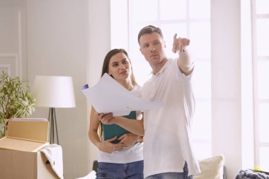 Genç İspanyol çift yeni ev planları bakarak, yüksek açı görünümü