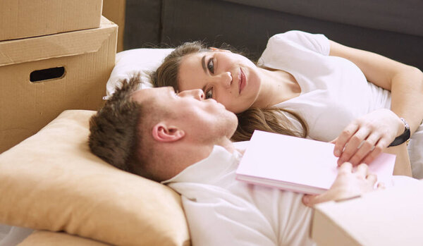 Young Vietnamese family looking through family photo album