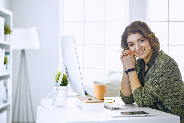 Young woman working with graphic tablet in office