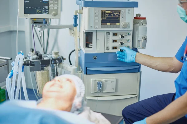 Several doctors surrounding patient on operation table during their work. Team surgeons at work in operating room — Stock Photo, Image