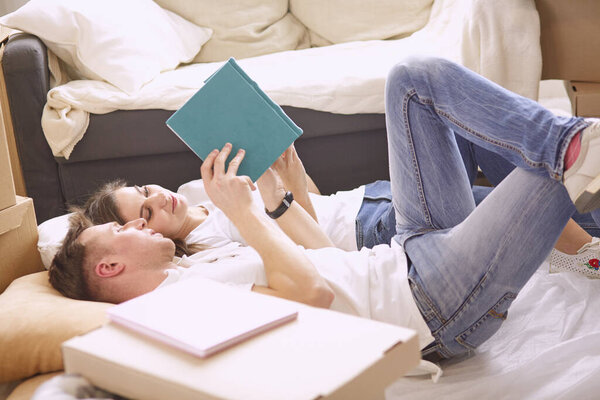 Young Vietnamese family looking through family photo album