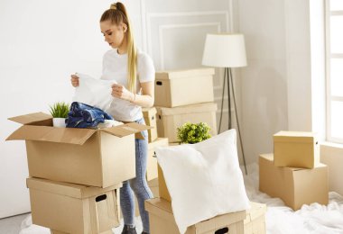 Kız yeni bir eve taşınırken bazı şeyleri ayrıştırıyor.