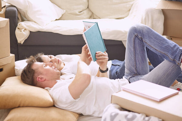 Young Vietnamese family looking through family photo album