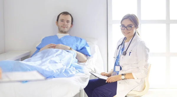 의사는 청진 기를 침대에 있는 환자의 심장 박동을 확인 — 스톡 사진