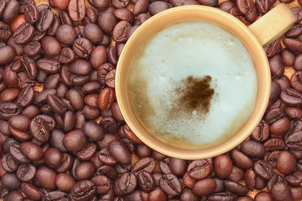 hot coffee on coffee seeds background