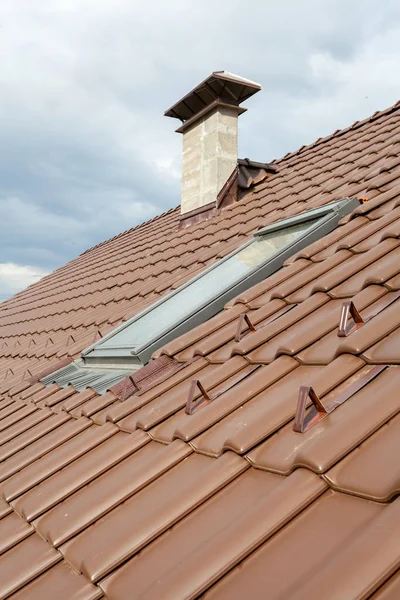 Új tető tetőablak, természetes piros cserép és a kémény. — Stock Fotó