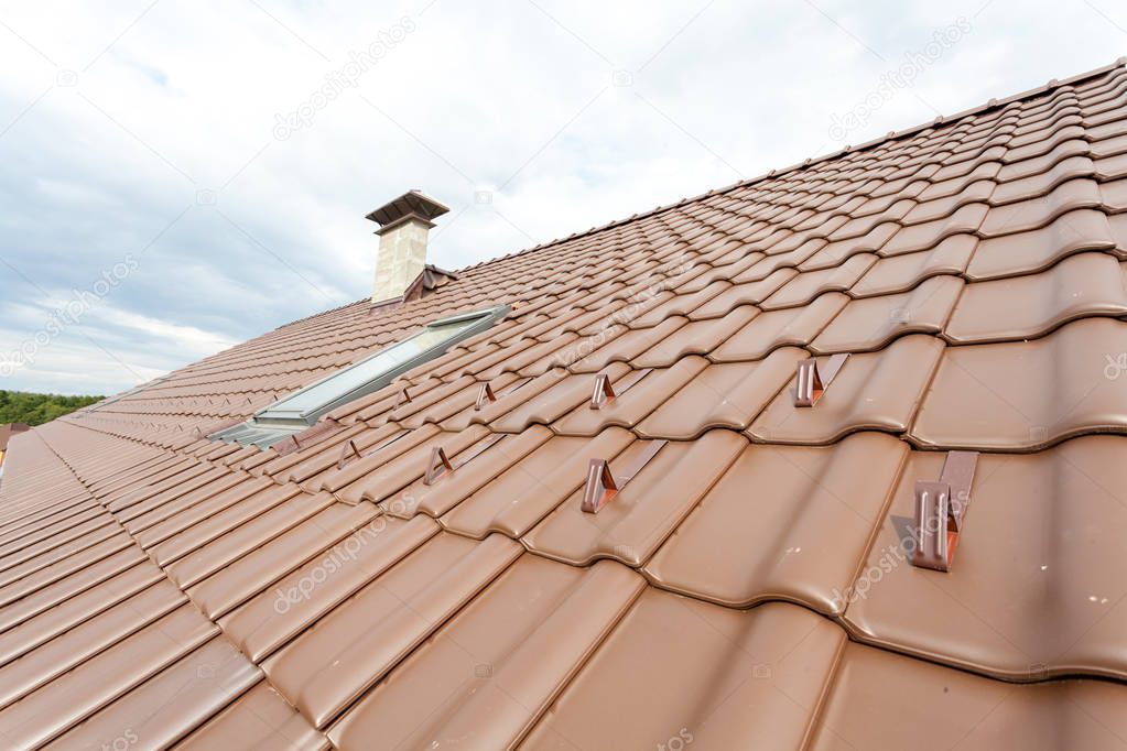 New roof with skylight, natural red tile and chimney.