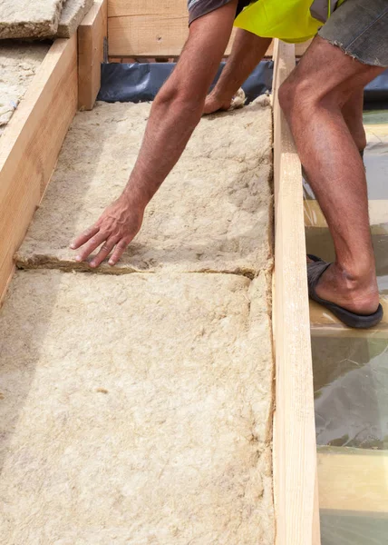 Roofer builder worker installing roof insulation material on new house under construction. — Stock Photo, Image