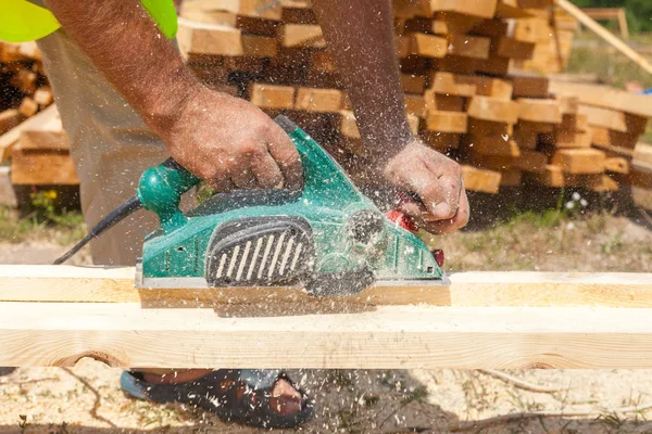 Carpenter working with electric planer. — Stock Photo, Image