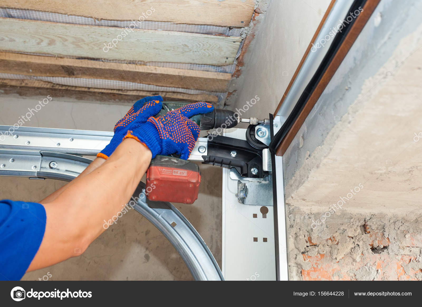 Garage Doors Installation Worker Installing Lifting System
