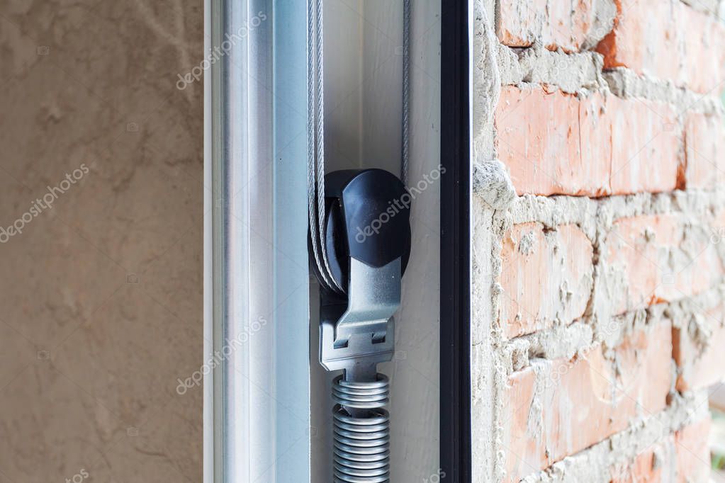 Garage doors installation. Close up of lifting system in metal profil.