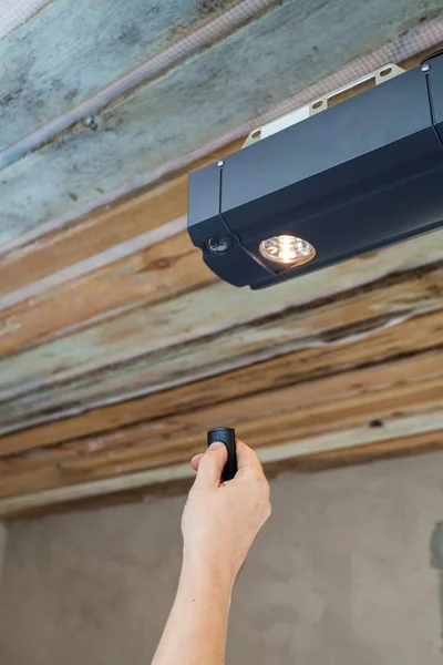 Garage doors installation. Contractor programming a mechanical garage door opener.