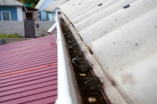 Špinavá dešťová mezera na střeše na azbestových břidlicových střechách potřebuje vyčistit . — Stock fotografie
