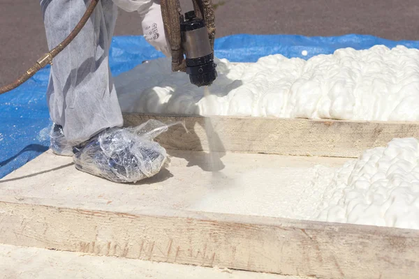 Technician spraying foam insulation using Plural Component Spray Gun. — Stock Photo, Image