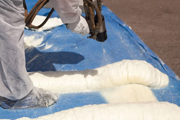 Technician spraying foam insulation using Plural Component Spray Gun. — Stock Photo, Image