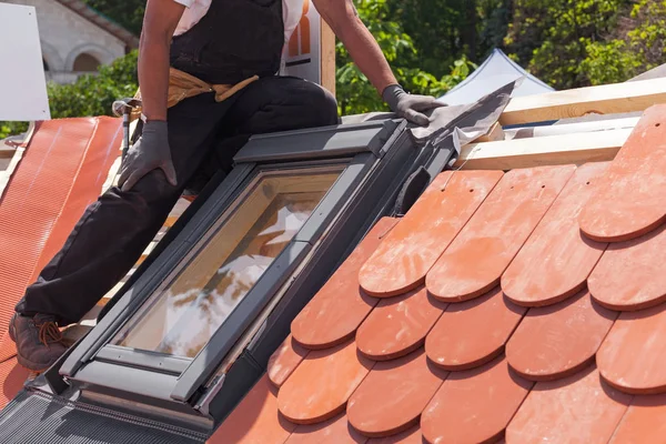 Installation of mansard windows on a new roof of red tiles. — Stock Photo, Image