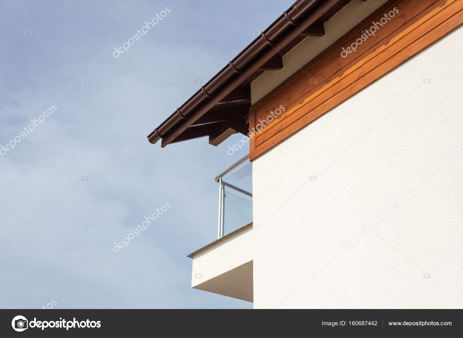 New house with brown rain gutter, white wall and balcony. — Stock Photo
