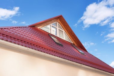 Red Metal tiled Roof with New Dormers, Roof Windows, Skylights and Roof Protection from Snow Board. clipart