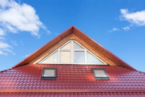 Red Metal tiled Roof with New Dormers, Roof Windows, Skylights and Roof Protection from Snow Board.