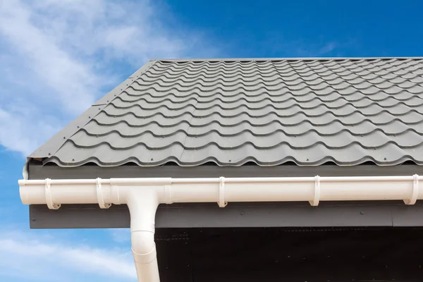 SIP panelu konstrukci domu. Nová šedá krytina střecha s bílým dešťovými žlábky. — Stock fotografie