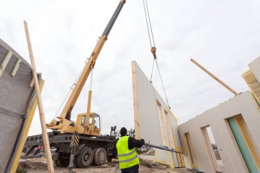 Çatı ustası Oluşturucusu işçi yapısal izolasyonlu paneller SIP yükleme vinç ile. 