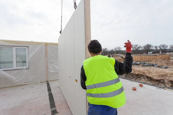 Roofer builder workers with crane installing structural Insulated Panels SIP. — Stock Photo, Image