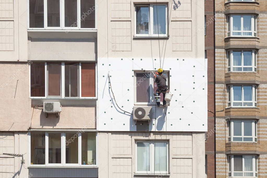 Wall Thermal insulation, industrial climbing, high-altitude work, insulation of walls with foam plastic or Styrofoam