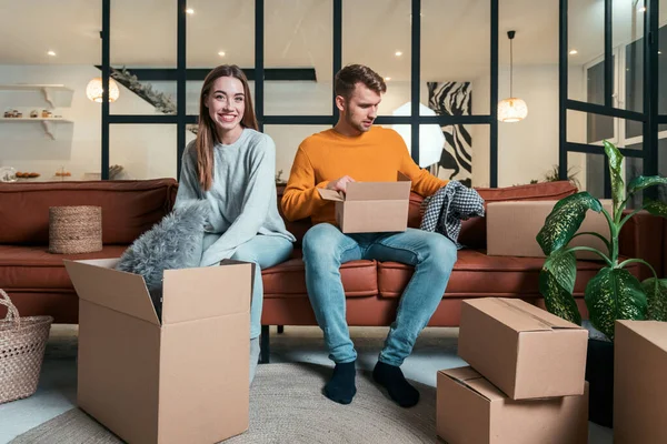 Mortgage Concept Concentrated Young Adult Husband Sitting Couch Unpacking Carton — Stock Photo, Image
