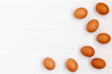 taze veya ham kahverengi yumurta beyaz ahşap zemin, üstten görünüm, fl