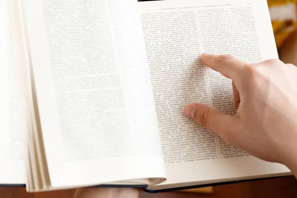 Joven sosteniendo libro y leyendo — Foto de Stock