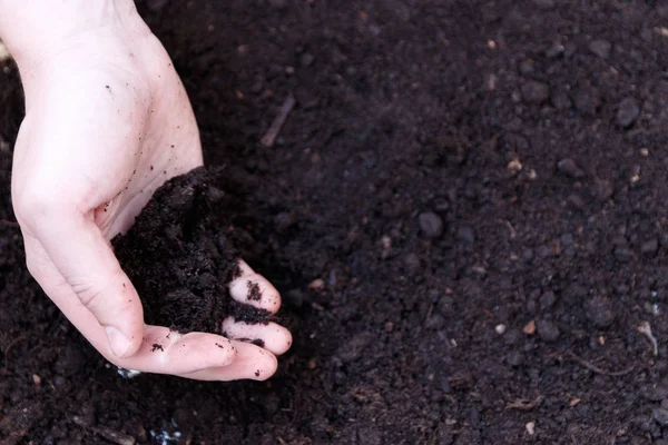 Man farmer holding soil. Earth day and ecology concept — Stock Photo, Image