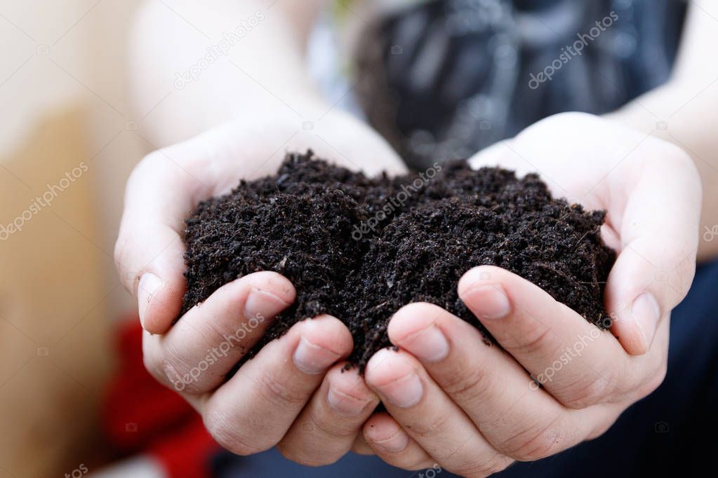 Man farmer holding soil. Earth day and ecology concept