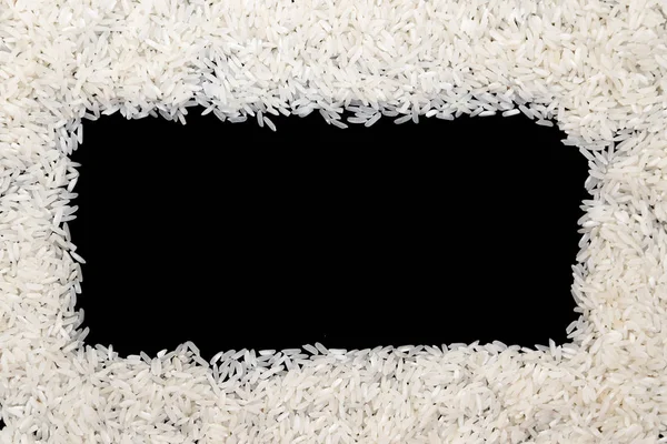 White rice scattered on black background. Copy space for text in — Stock Photo, Image