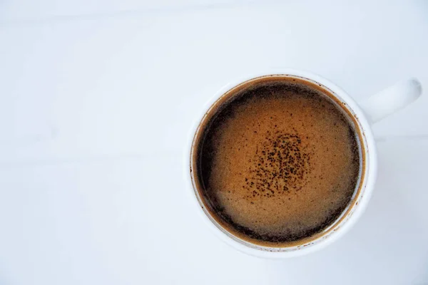White cup of coffee on white wooden background. Top view. Copy s — Stock Photo, Image
