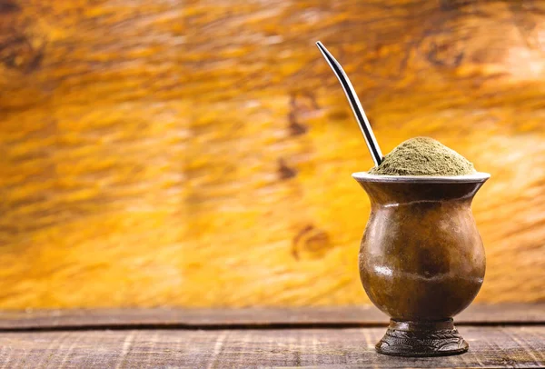 Єрба парує чай у дерев'яній мисці на дерев'яному столі. Традиційний напій з Бразилії, Аргентини, Парагваю та Південної Америки.. — стокове фото