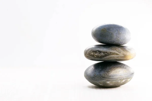 Hromada kamenů izolovaných na bílém pozadí, Kameny pro masáž a zenový životní styl. Mystické kameny v rovnováze. — Stock fotografie