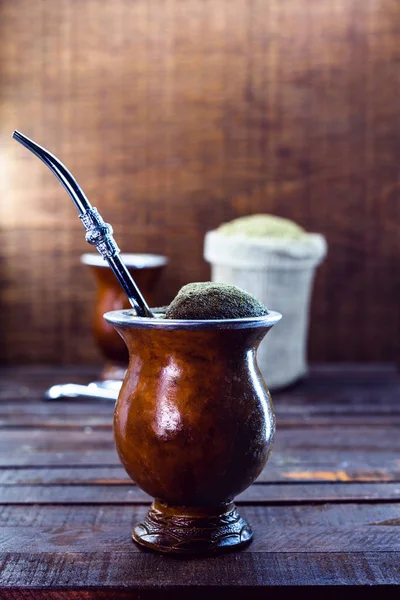 Gaucho yerba mate tea, the chimarrão, a typical Brazilian drink, traditionally in a bombilla stick cuiade gourd against a wooden background. Rio Grande do Sul, favorite drink of the gauchos.