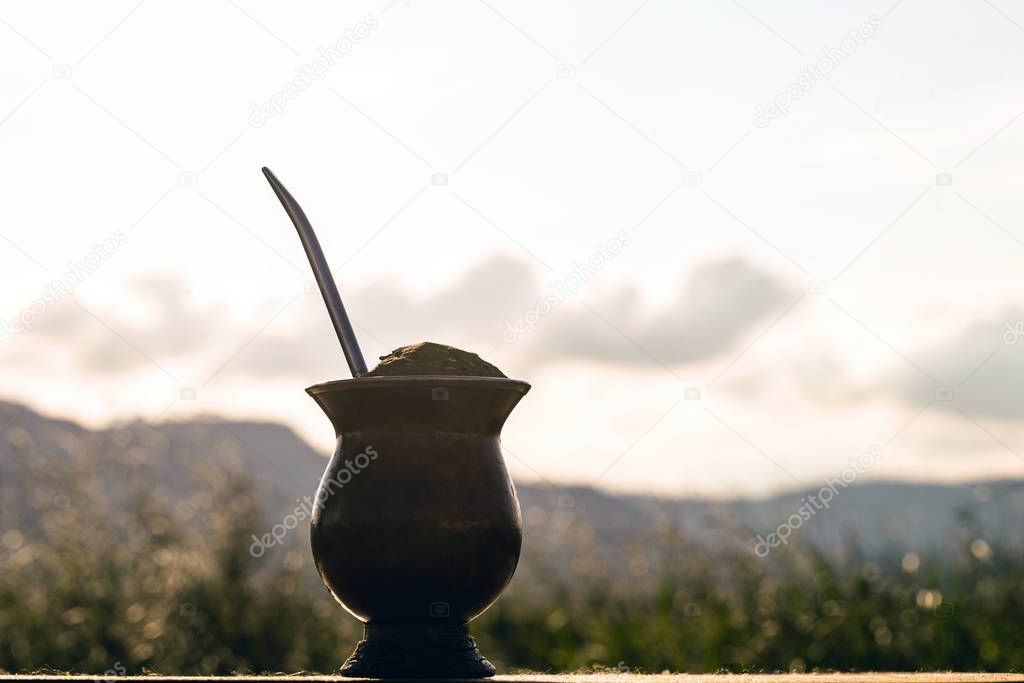 Chimarrão, traditional yerba mate tea from the state of Rio Grande do Sul. Selective focus. Typical drink with Serra Gaucha in the background.