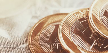 Brazilian real coins, with golden tone. Banking savings or investment concept. Coins a real selective focus.