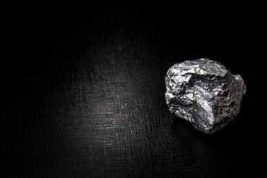 big big silver nugget on black background. Raw silver stone, silver nugget native to Liberia, isolated on black background. Mineral extraction. clipart