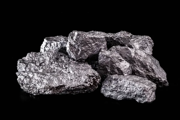 Large silver nugget on black background. Raw silver stone, silver nugget native to Liberia, isolated on black background. Mineral extraction. — Stok fotoğraf