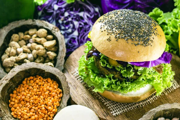 roasted vegan hamburger, made of vegetables and proteins. Healthy and vegetarian life concept. Colorful food, peppers, red cabbage, tomatoes, onions, chickpeas, soy, lettuce and lye