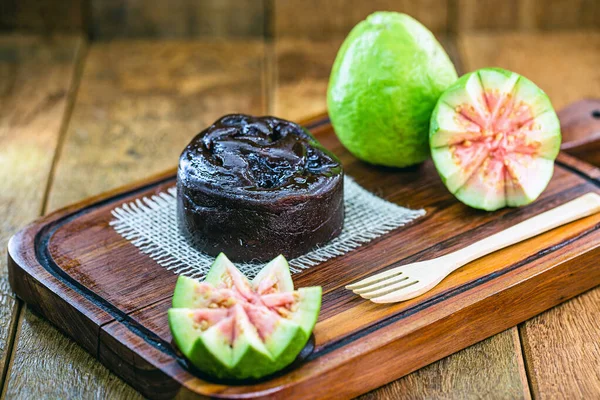 sweet made from guava fruit. creamy guava paste on rustic background.