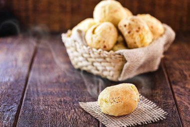 cheese bread made in minas gerais, with selective focus. Rustic background, concept of brazilian cuisine. clipart