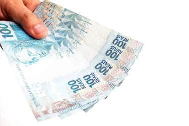 Brezilya 'dan 100 reais' in banknotları, sosyal yardım ödeme günü. 100 reais erkek eliyle teslim ediliyor, devletten acil yardım..
