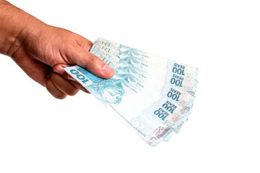Brezilya 'dan 100 reais banknot, izole edilmiş beyaz arka planda erkek eliyle tutulmuş. Brezilya 'dan 100 reais' in banknotları, ödeme günü..