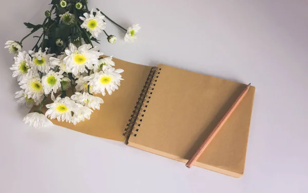 Blank area note book or diary with flower